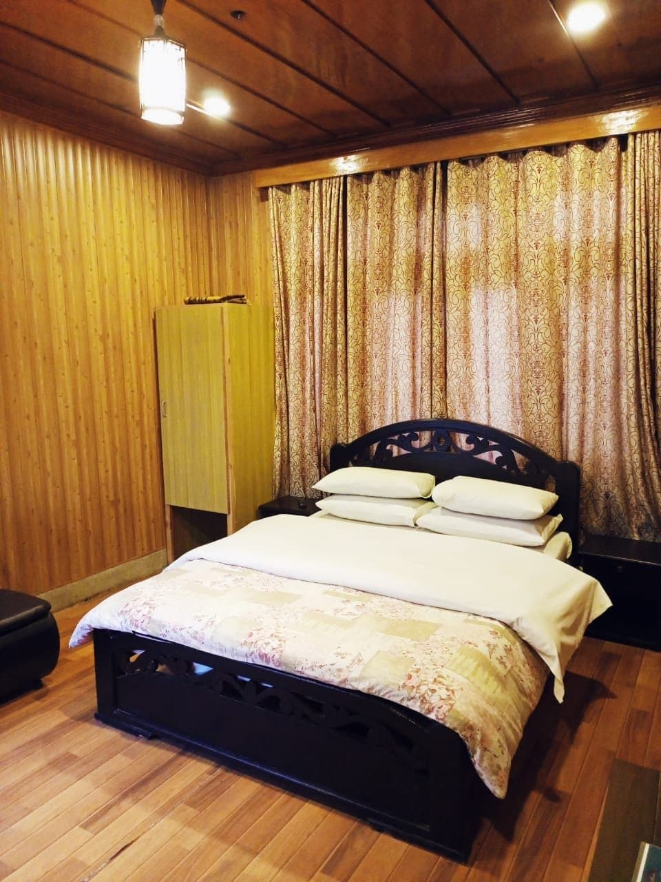 Standard room with a double bed and warm wood-panelled interior